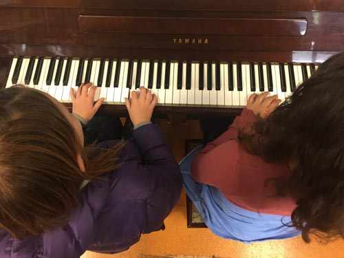 Kids playing piano